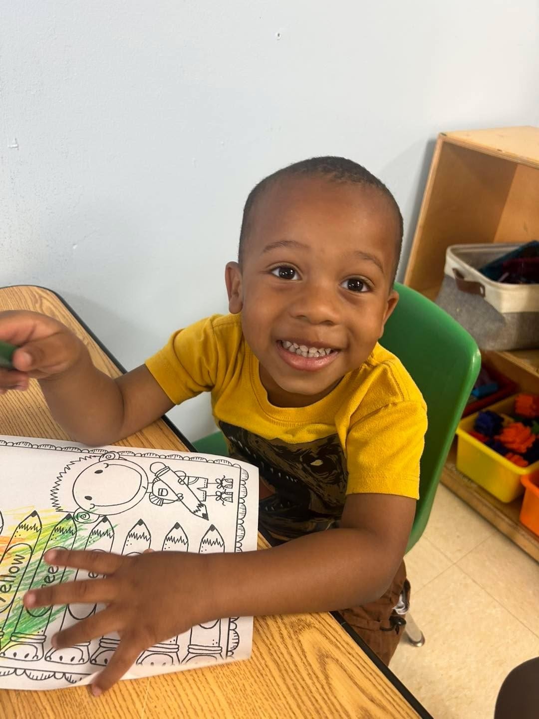 Preschooler playing with colorful building toys in classroom